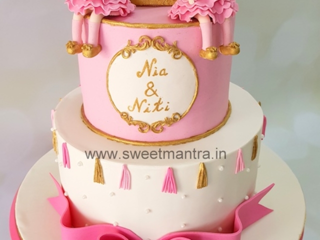 Customized 2 layer fondant cake for twin girl's 1st birthday in Pune