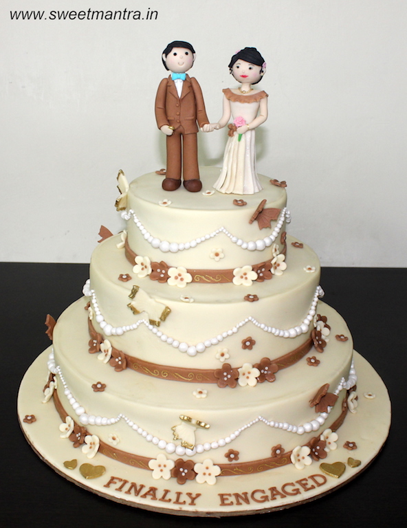 3 tier designer cake with edible couple topper for Wedding Reception in Pune