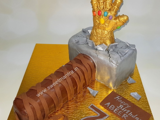 Thanos tearing Thor Hammer shaped 3D cake for boy's birthday in Pune