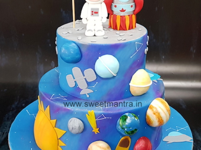 Galaxy theme handpainted cake with planets and rocket in Pune