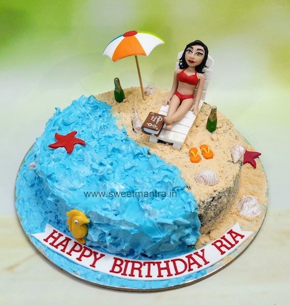 Birthday girl chilling on beach cake in bikini